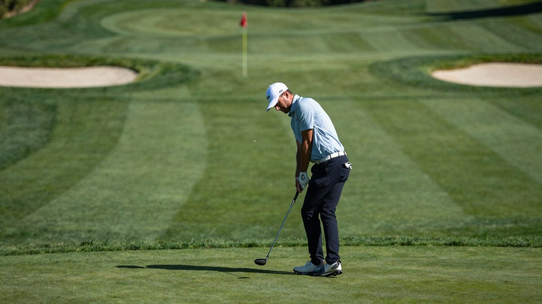 Golfer Trent with 7-iron on Grayhawk Raptor's 2nd hole.